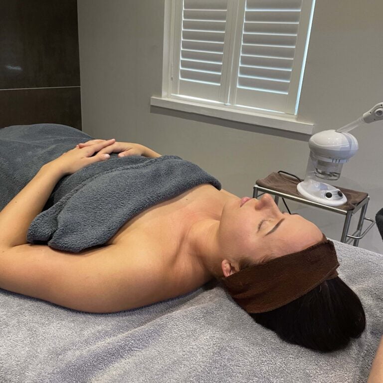 woman lying down on treatment table relaxing